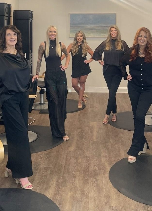The Studio 4 Salon stylist team standing in the salon